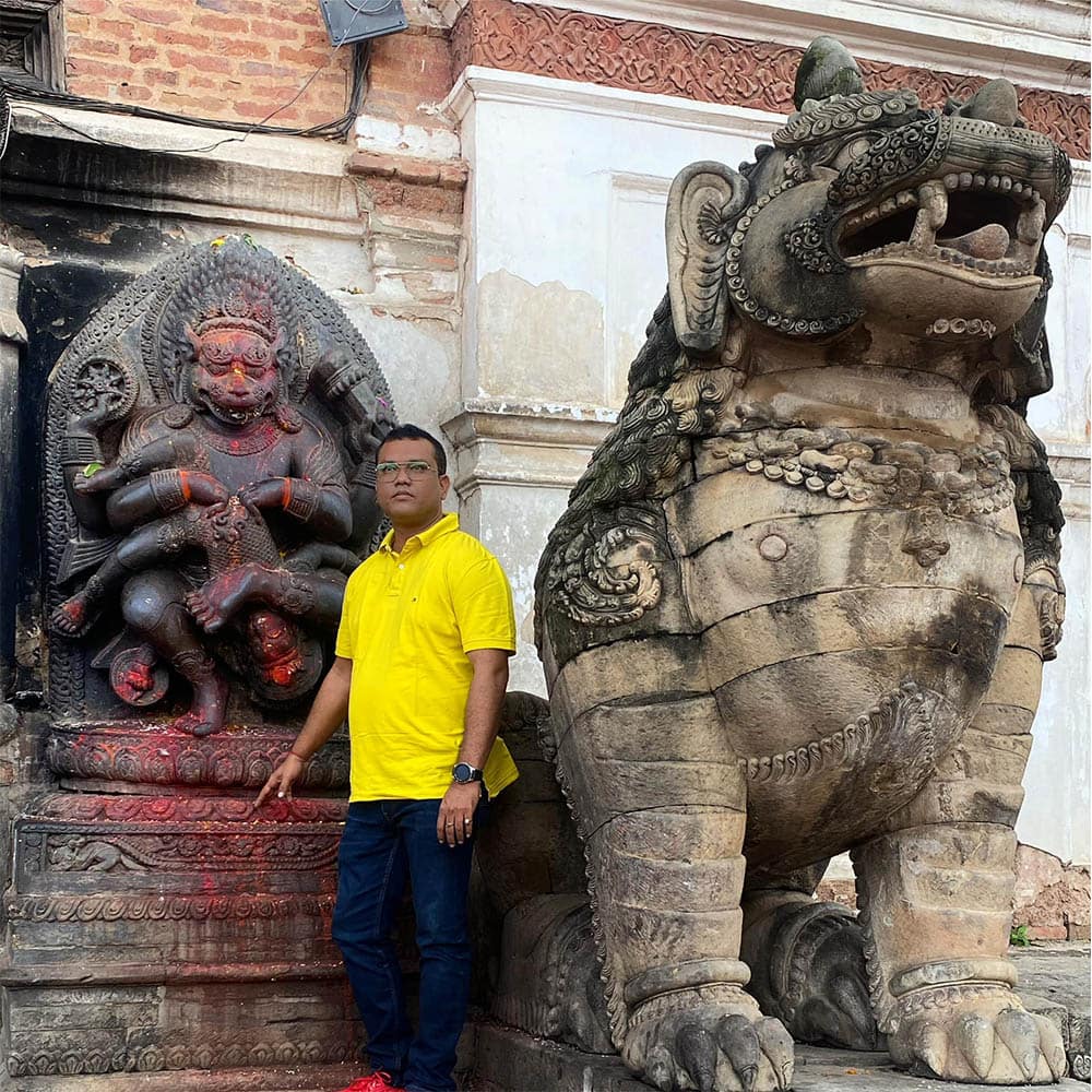 Astrologer Sailyajit Baruah with the statue of Lord Narsingha